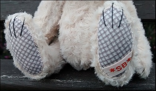 Rose's paws with the SB label